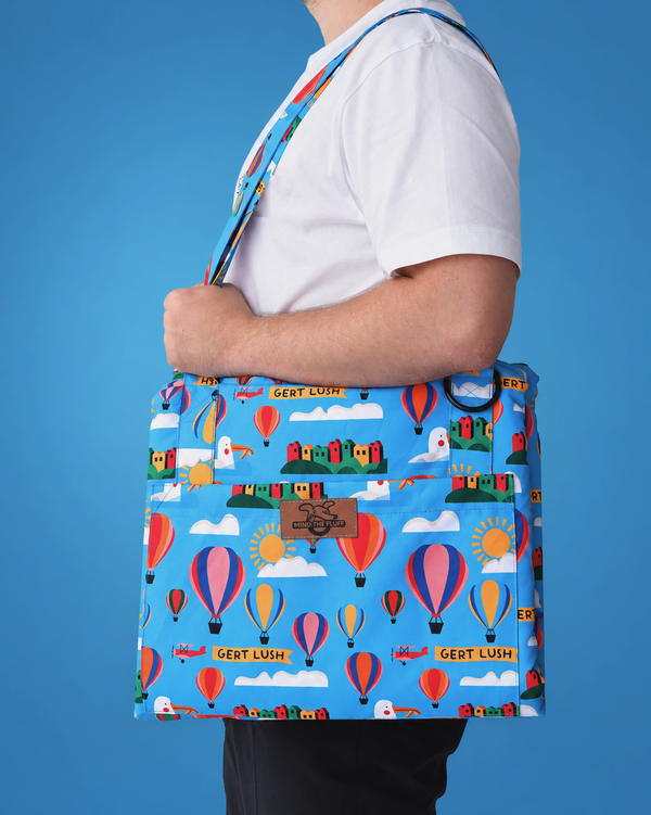 Gert Lush Bag to Mat carried over the shoulder, with a blue Bristol and hot-air-balloon print