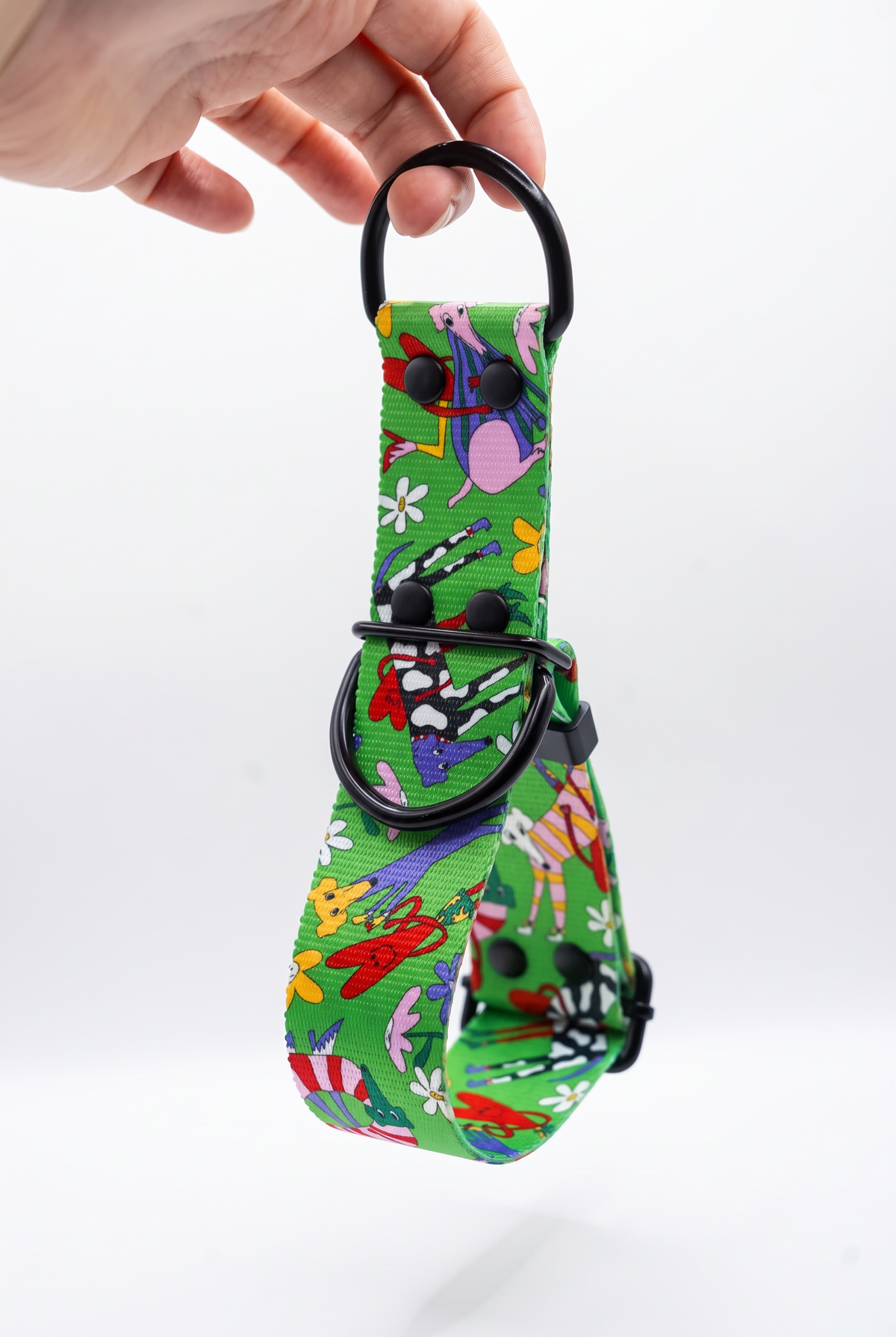 Oopsie Daisy martingale collar hanging from its black D-ring, showing the chain-free fabric loop that tightens gently