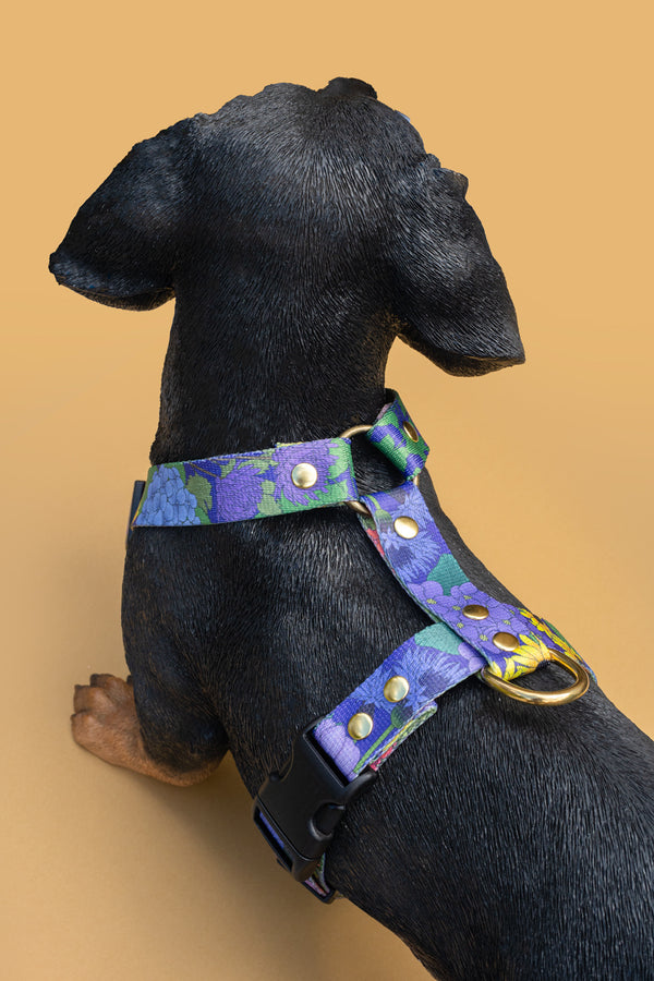 Rear view of a purple Once and Floral dog harness, showing the adjustable straps and brass D-ring.
