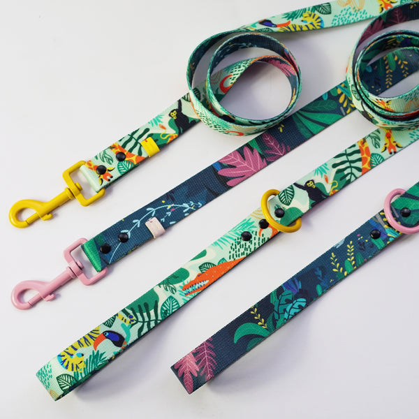 Rainfurrest double-ended dog leads with a green and pink tropical leaf print on dark teal, with yellow and pink clips