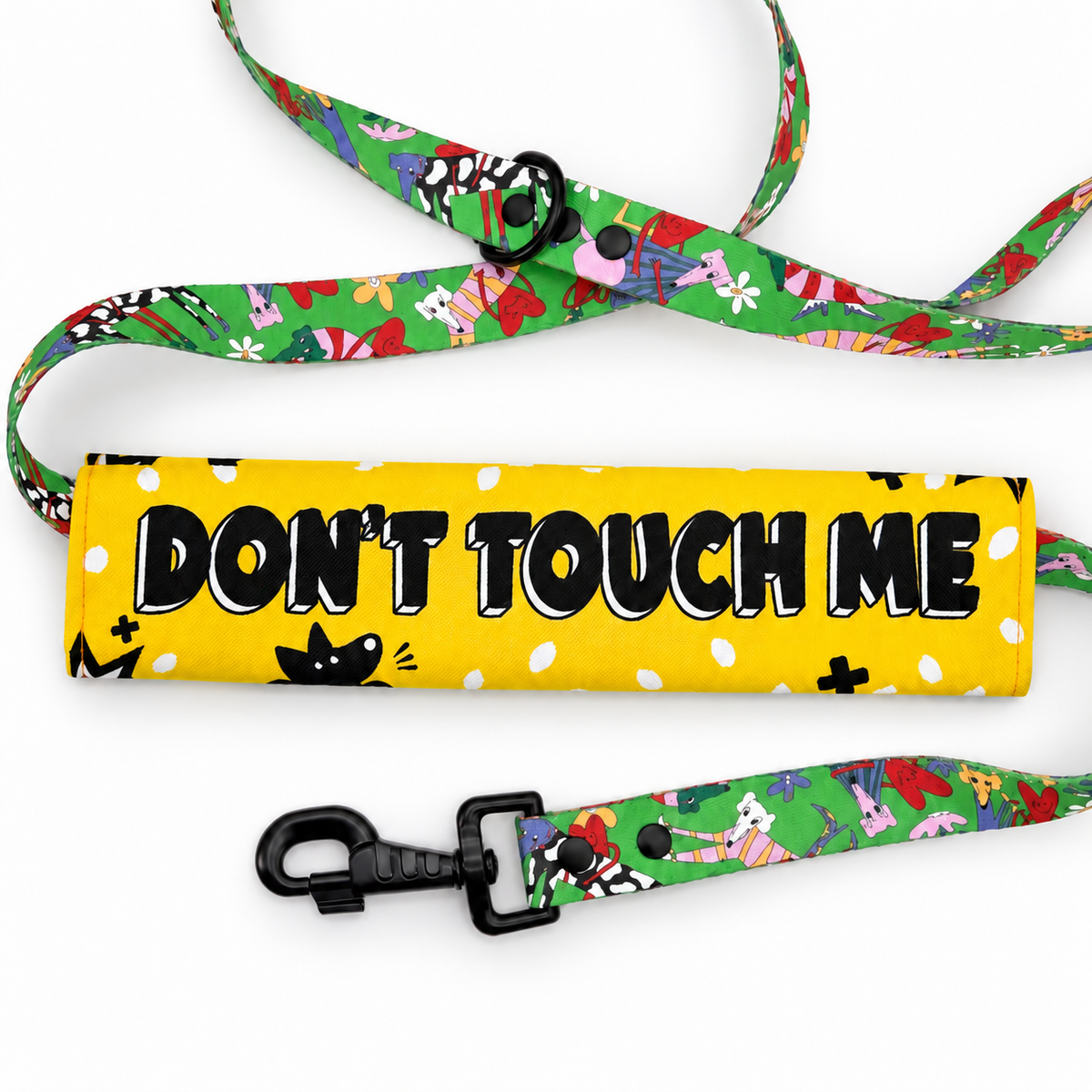 Don't Touch Me dog lead sleeve on a green patterned lead.