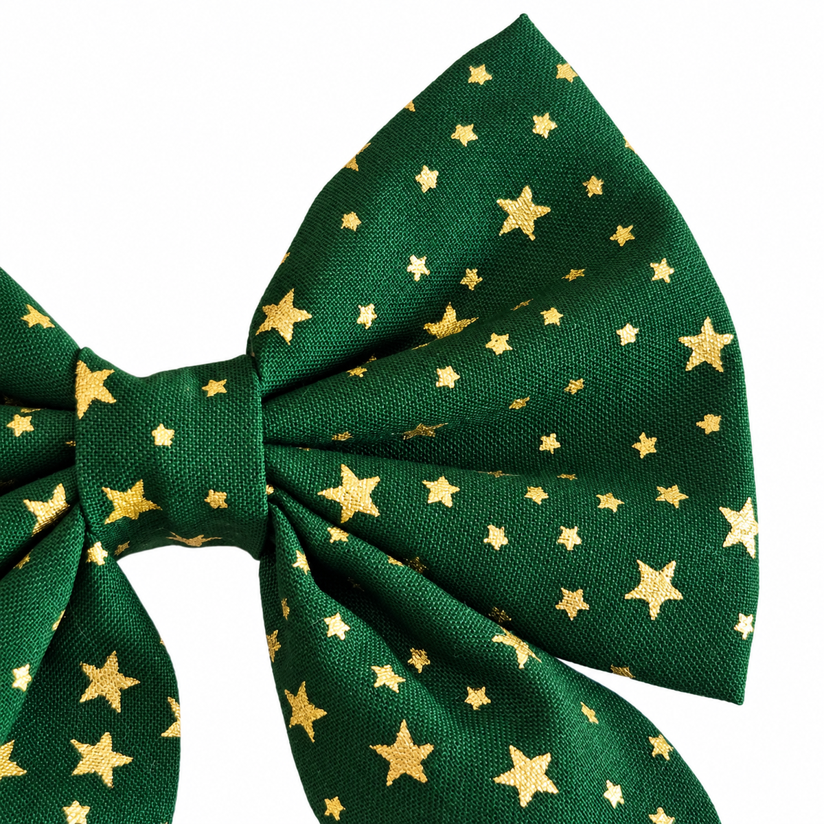 Close-up of the green Christmas dog bow tie showing gold stars and the gathered sailor bow fabric.
