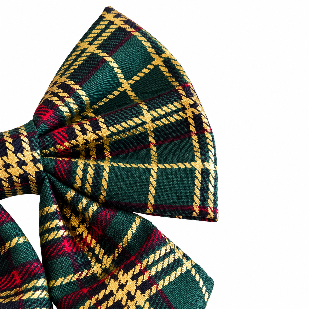 Close-up of the green tartan dog bow tie showing gold checks, red stripes and gathered fabric.