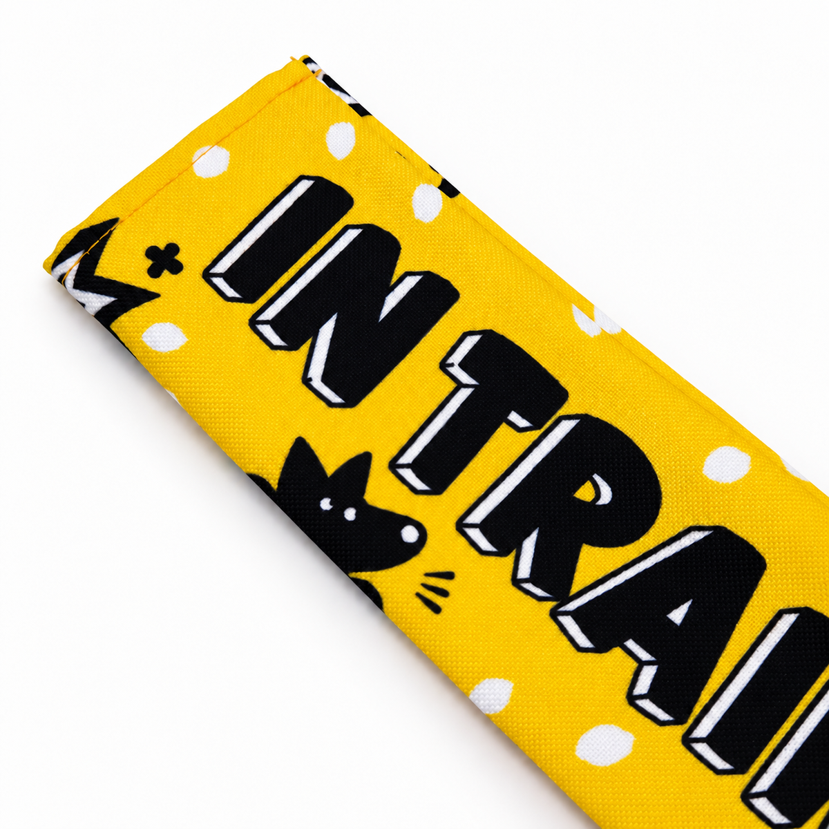 Fabric and stitched edge of the yellow In Training dog lead sleeve.