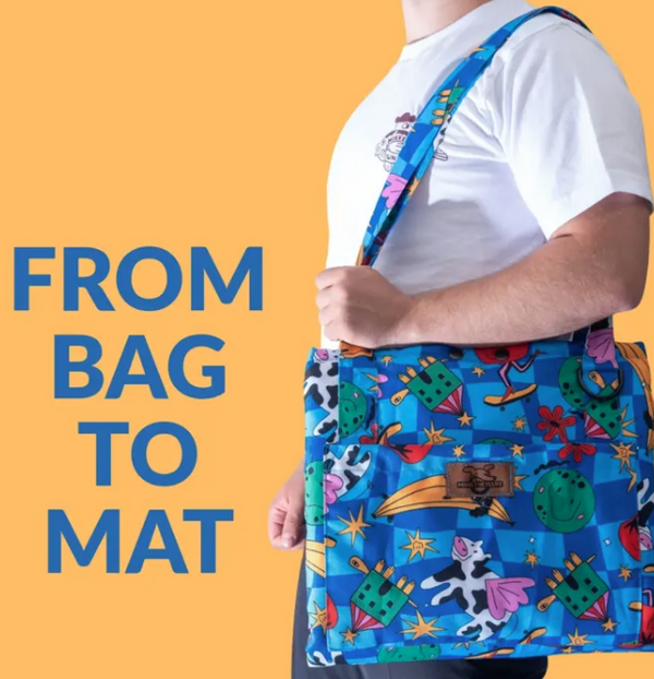Holy Cow Bag to Mat carried over the shoulder, with a blue flying-cow print